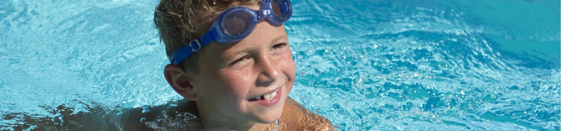 A child is swimming in a pool